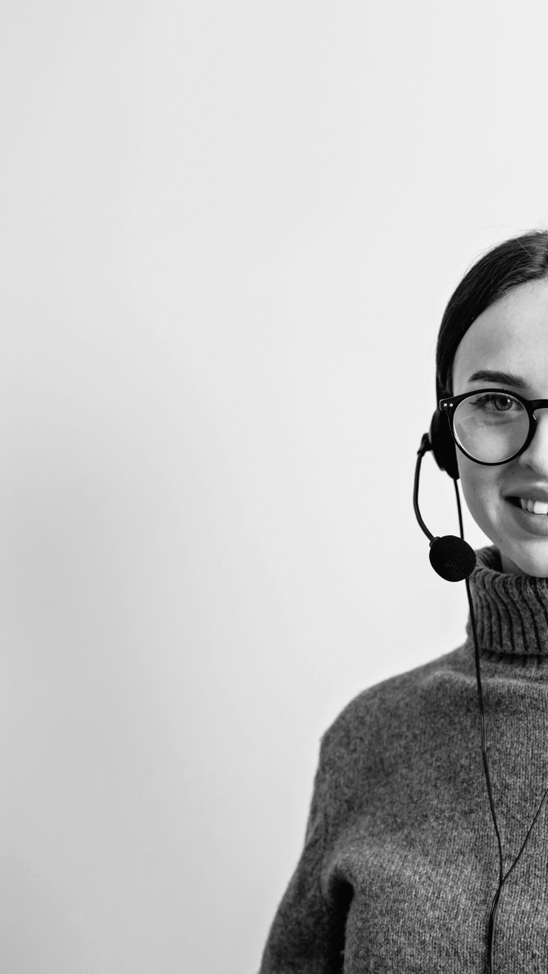 call center agent with glasses smiles black and white photo